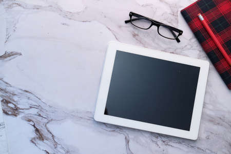 Flat composition of digital tablet and office stationary on tiles backgroundの写真素材
