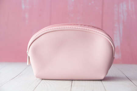 pink color women casual bag on wooden backgroundの写真素材