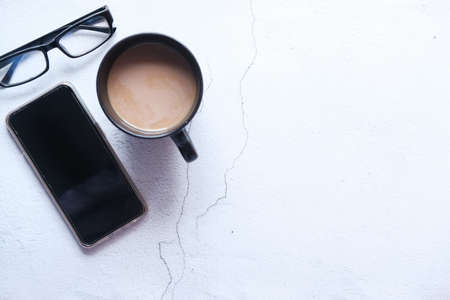 flat composition of smart phone and coffee on tableの写真素材