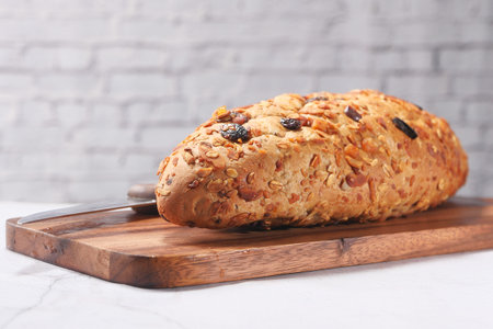 close up of baked brow bread on chopping board .