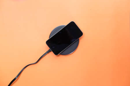 charging Smartphone Using Wireless Charging Pad, top viewの写真素材