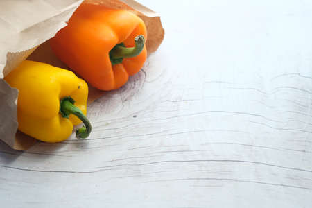 Yellow orange color capsicum on wooden backgroundの写真素材