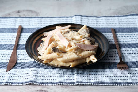 homemade cooked pasta in a plate on table .の写真素材