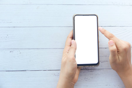 high angle view of women hand using smart phone with copy space