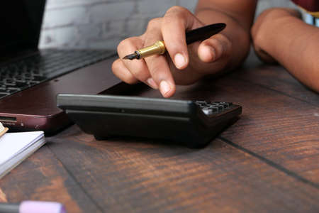 Close up of man hand using calculatorの写真素材