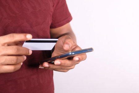 Man hand holding credit card and using smart phone shopping onlineの写真素材