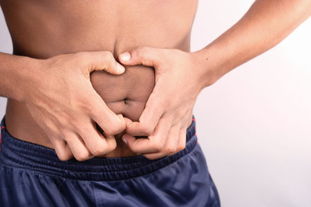 young man suffering stomach pain close up.の写真素材