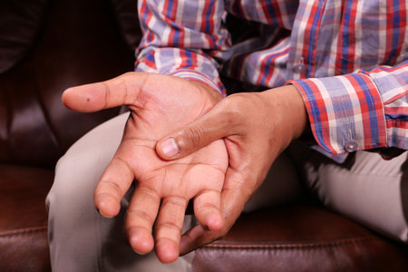 man suffering pain in hand close up