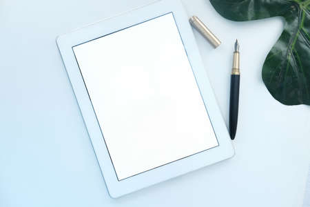top view of digital tablet with office suppliers on white backgroundの写真素材