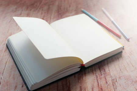 open book and a pencil on wooden tableの写真素材