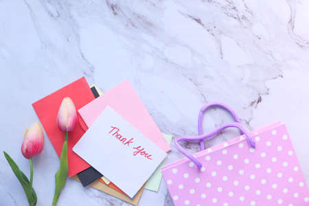 thank you message on a paper note tulip flower on tiles backgroundの写真素材