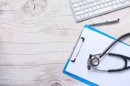 doctors workplace with container, keyboard and prescription on desk.の写真素材