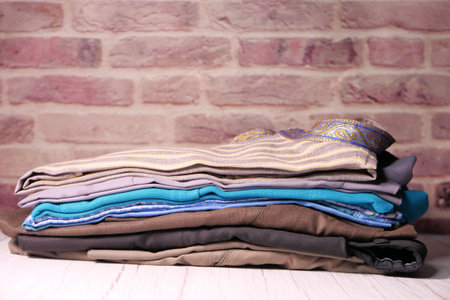 close up of stack of clothes on table .