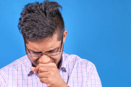 Sick man got flu allergy sneezing and blowing noseの写真素材