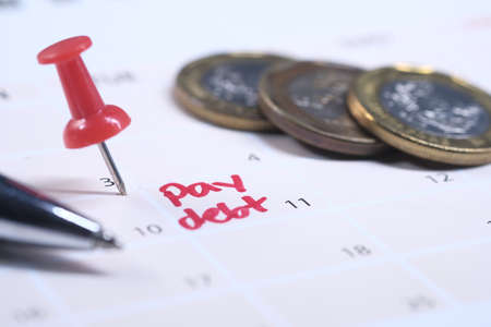 Close up of pay debt word on calendarの写真素材