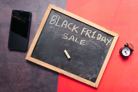 black friday concept with black board and clock on color background ,の写真素材