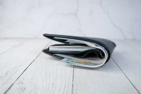 Close up of cash in wallet on table.の写真素材