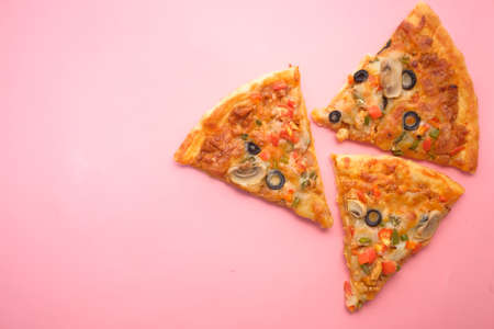 Slice of cheese pizza on a plate on pink background .の写真素材
