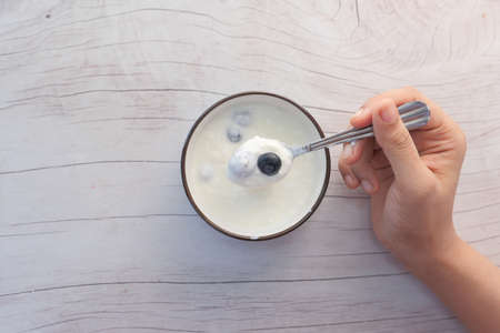 close up of fresh yogurt with blue berry in a bowlの写真素材