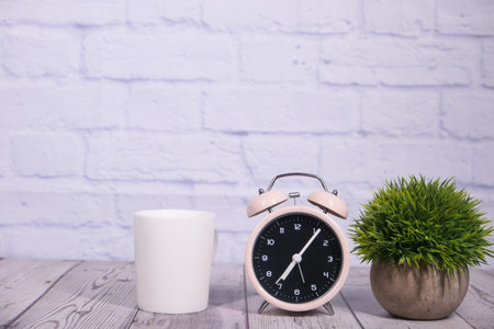 coffee mug and clock on table close up