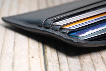 close up of credit cards in a wallet on wooden backgroundの写真素材