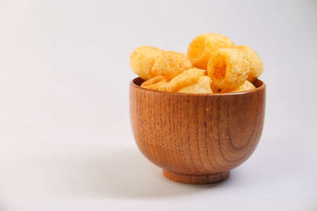 Bowl with tasty potato chips on white background .の写真素材