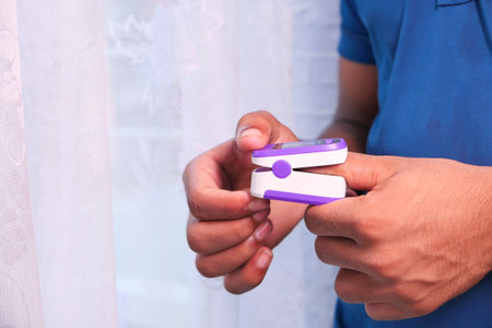 young man hand using pulse oximeter