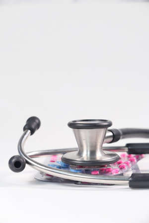blister pack and stethoscope on white backgroundの写真素材