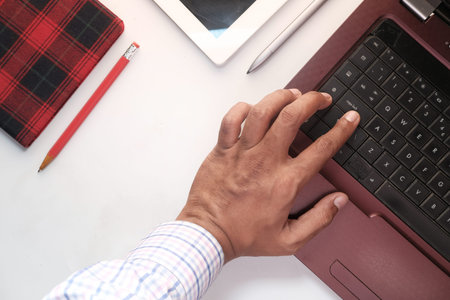 Close up of man hand typing on laptop.