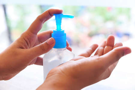 women hand using sanitizer gel for preventing virus with copy spaceの写真素材