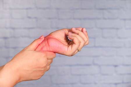 Young women hands suffering wrist pain