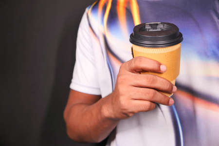 hand holding reusable eco coffee cup close upの写真素材