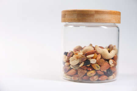 a jar of mixed nut isolated on white backgroundの写真素材