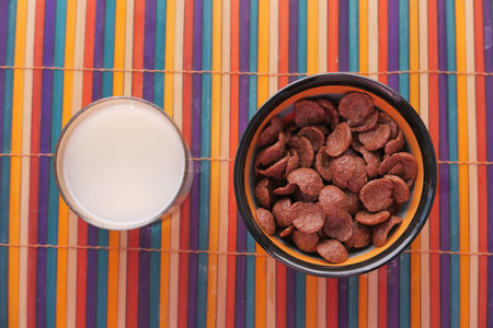 Chocolate breakfast cereal in a bowl on table.