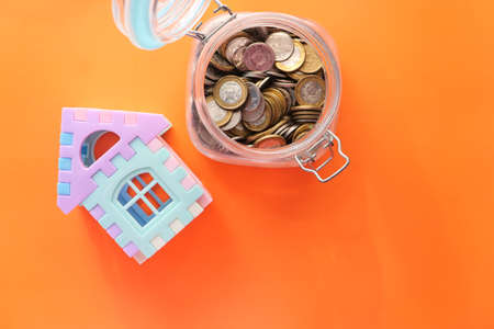 the concept of finance concept with stack of coins and houseの写真素材