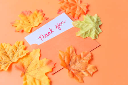 thank you message and envelope on orange backgroundの写真素材