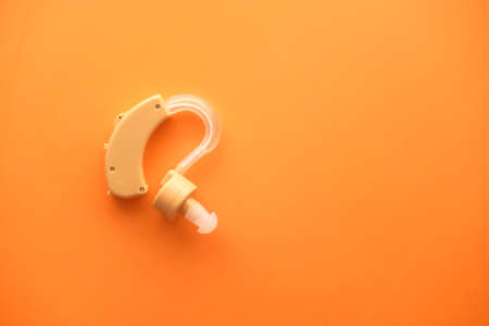 Hearing aid equipment on orange backgroundの写真素材