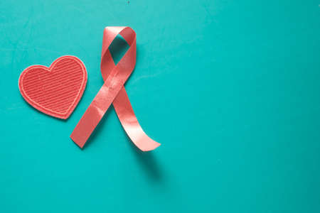 Red ribbon HIV and heart shape on green backgroundの写真素材