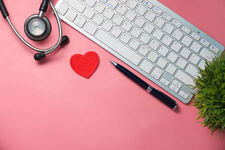 doctors workplace with container, keyboard and prescription on desk.の写真素材