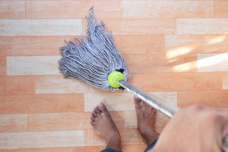 Home, housekeeping concept cleaning wooden floor with mop.