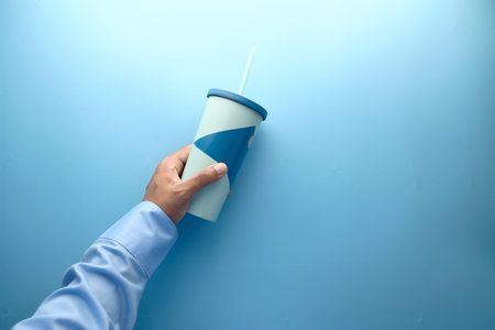 hand holding reusable eco coffee cup close up
