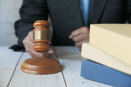 close up of persons hand striking the gavel.の写真素材
