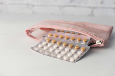 birth control pills on wooden background, close upの写真素材