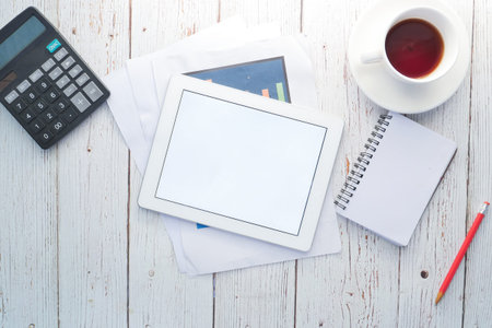 top view of digital tablet with office suppliers on table