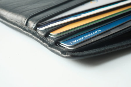 close up of credit cards in a wallet on wooden background