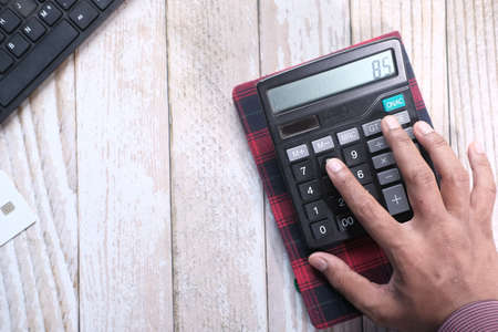 Close up of man hand using calculatorの写真素材