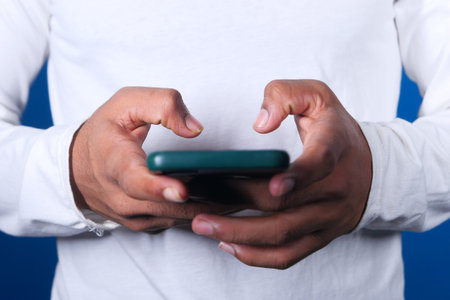 Close up of young man hand using smart phone.の写真素材