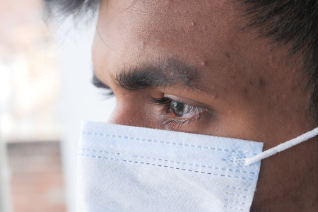 Close up of man with protective face mask looking at camera