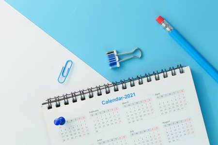 2021 calendar with pen and push pin on color backgroundの写真素材