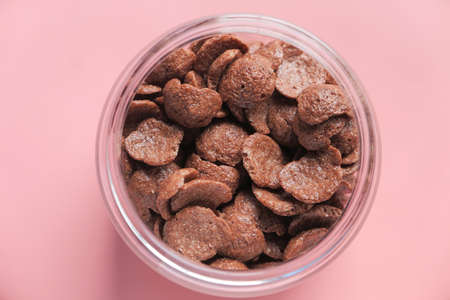 Top view of chocolate corn flakes in a bowl on pinkの写真素材